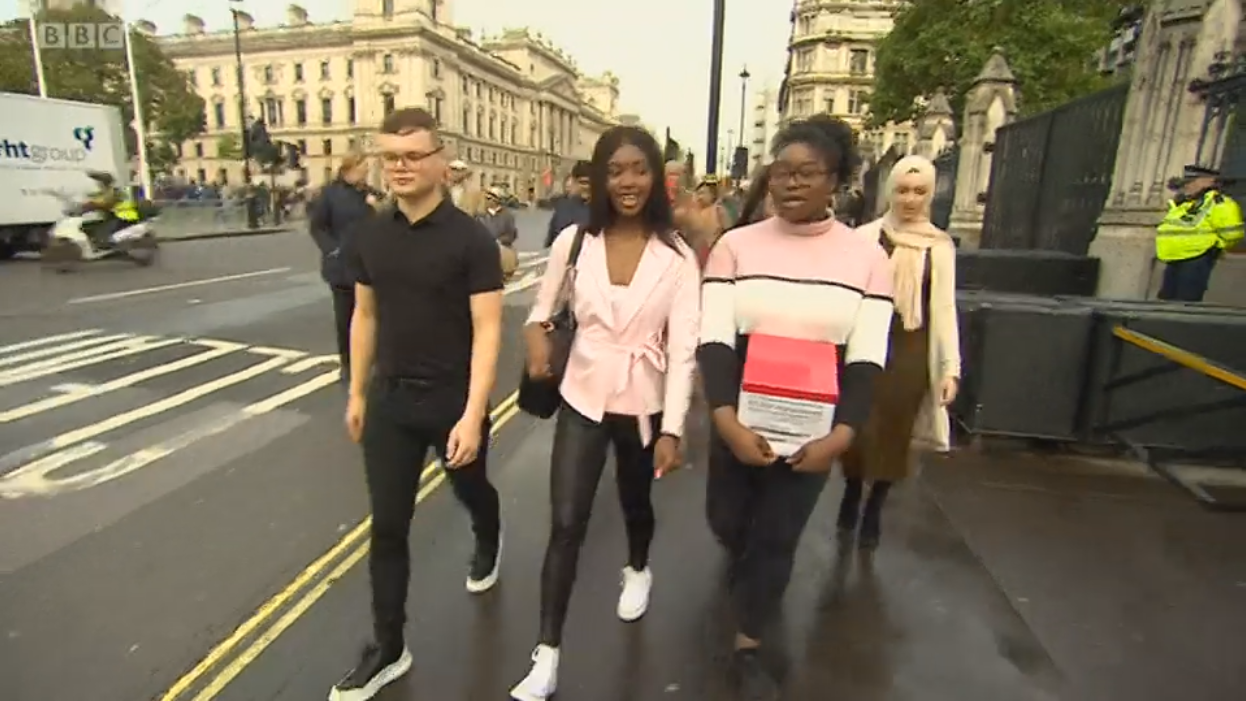 Students in London visiting Parliament walking down the street